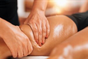 lymphatic drainage massage therapy - therapist rubbing legs
