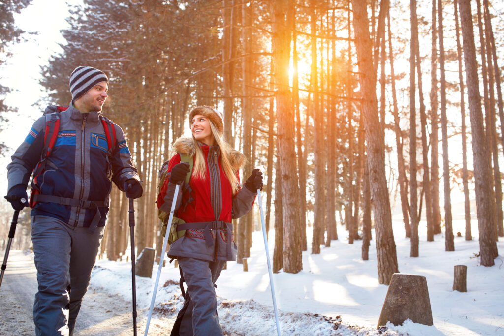 Love couple hiking in forest on winter